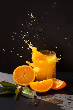 orange juise splash in the bright sun with black background