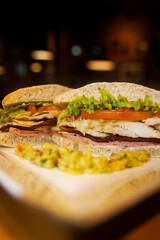Sandwich with white bread, lettuce, tomatoes and chicken