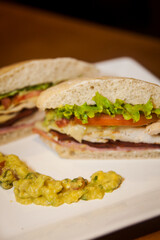 Sandwich with white bread, lettuce, tomatoes and chicken