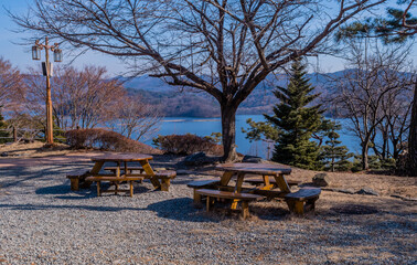 Two round wooden picnic tables