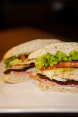 Sandwich with white bread, lettuce, tomatoes and chicken