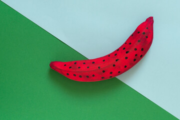 green banana with two pears in the shape of a smiling face on a purple background