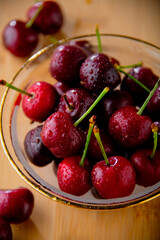 Ripe red cherries in glass bowl.