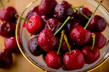 Ripe red cherries in glass bowl.