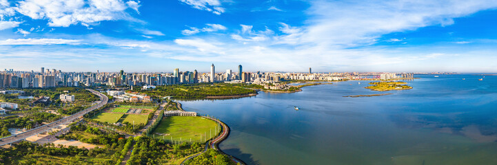 Fototapeta na wymiar Haikou City Skyline in the Binhai Avenue Central Business District with Office Buildings and Evergreen Park View, Hainan Province, The Largest Pilot Free Trade Zone in China, Asia. Panorama View.