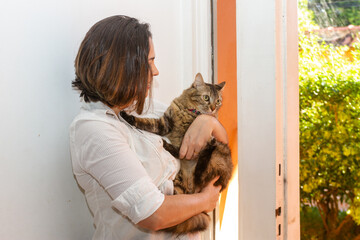 white woman with cat on her lap