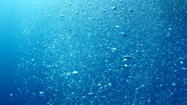air bubbles slow  underwater coming up scenery dark blue and sun shine ocean scenery