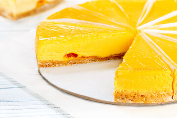 Fresh cheesecake with mango fruit. Close-up.
