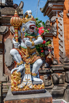 Statue of Hanuman, Hindu god and divine monkey (vanara) companion of the god Rama, holding gada (mace). Bali, Indonesia. Vertical image.