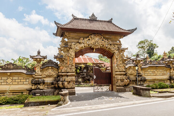Fototapeta premium Entrance gate of a traditional Balinese house in Desa Katung in Kintamani, Bangli, Bali, Indonesia.