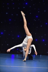 Young teenage girl in white jersey perform modern dance