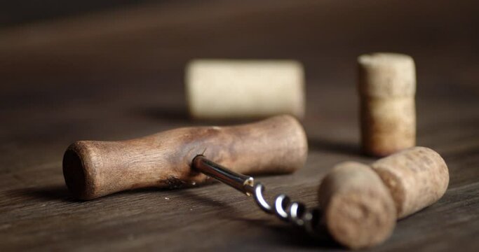 On the table with a corkscrew falling the corks.