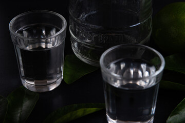 Brazilian cachaça in dark fume with lemons and salt. At the end of the bottle is written 