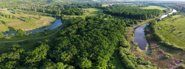 Fototapeta na wymiar Aerial view on forest with river and pond. Old and new riverbeds landscape.