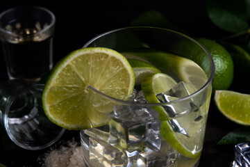 Caipirinha typical Brazilian drink with cachaca, lemon and sugar on dark background