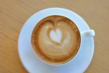 hot latte coffee drink put on wooden table in cafe restaurant