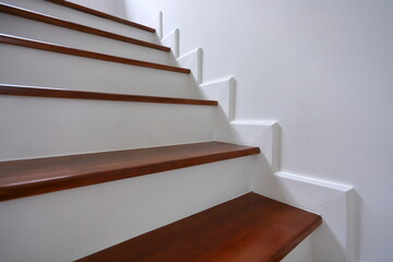 brown wooden stair and white wall in residential house