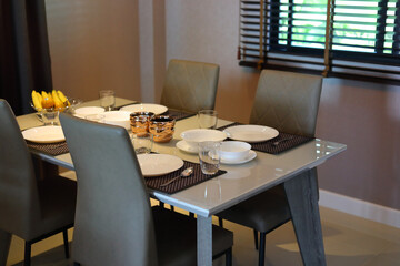 dish ware sets arrange on dining table inside eating room of modern home interior