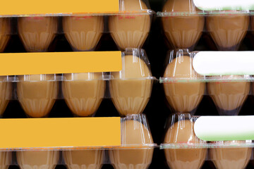 Chicken eggs in a transparent plastic tray on shelf in supermarket