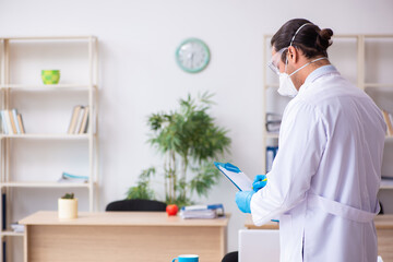 Young male doctor virologist in the office