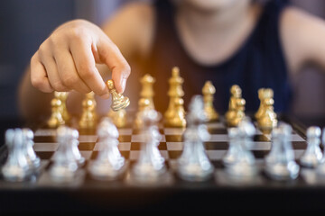 close up hand of woman playing chess game, strategic business leadership successful teamwork. business leader concept.