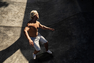 Fototapeta na wymiar Young skateboarder skateboarding on skatepark 