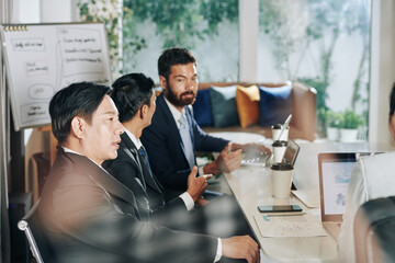 Business people gathered in meeting room to discuss anti-crisis management strategy