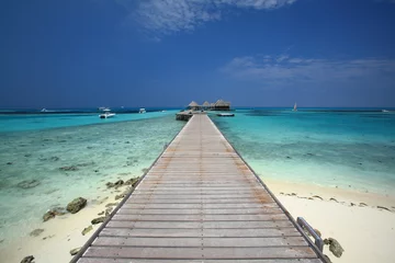 Fotobehang Bridge into the sea at Maldives Island © maodoltee