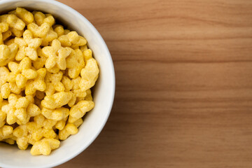 Top view image of star shaped honey cereal inside a glass for morning breakfast.