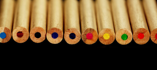  Colored crayons on a black background. Shallow depth of field 