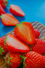Strawberries on a wood plate close up