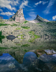 Rocks of amazing shape are reflected in the lake. Sayan Mountains, Natural Park Ergaki. Siberian...