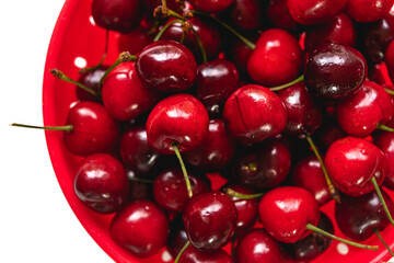 Fresh ripe cherries in colander, close up, view from above