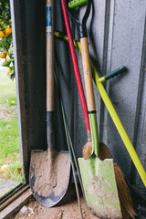 Garden Tools leaning in garden shed covered in dirt