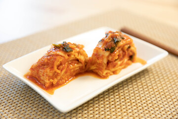 Close up image of Korean traditional fermented food, Kimchi with wooden chopstick on a table.