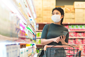 new normal after covid epidemic young smart asian female shopping new lifestyle in supermarket with...