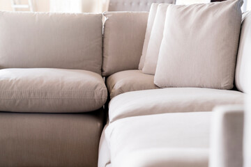 Fototapeta na wymiar soft cozy pollows on modern sofa background home design concept