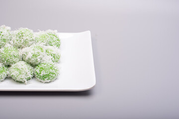 A set of traditional confectionery famous in Malaysia,Indonesia and Singapore,know as Buah Melaka or ondeh-ondeh ,isolated over grey,food photography concept 