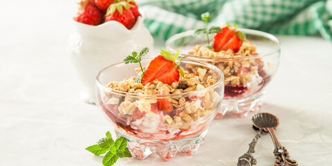 summer breakfast - cottage cheese with strawberry in a glass bowl on a table, selective focus