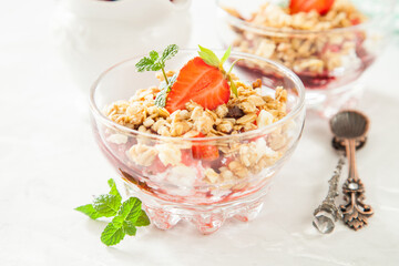 summer breakfast - cottage cheese with strawberry in a glass bowl on a table, selective focus