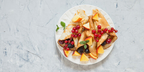 pancakes with berries in a plate on a table, selective focus,  top view
