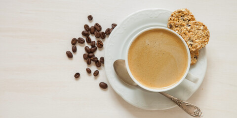 coffee in a cup and oat cookies on a table, selective focus, top view