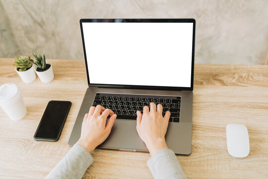 woman using laptop and working on wooden table