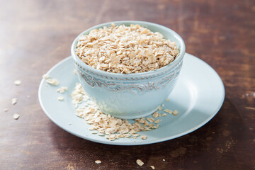 oat flakes in a bowl on a table, selective focus