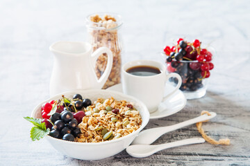 muesli with berries in a plate on a table, selective focus