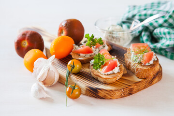 tomatoes and sandwiches on a board, selective focus