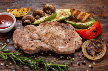 steak with vegetables lies on a wooden table