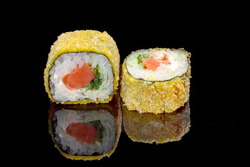 Sushi and rolls on a black mirrored background.
