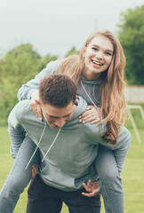 Obraz premium A girl sits on a guy's back,