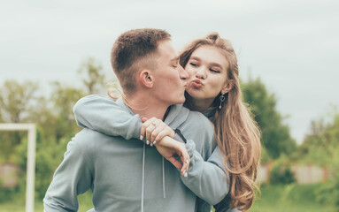 
A girl sits on a guy's back,